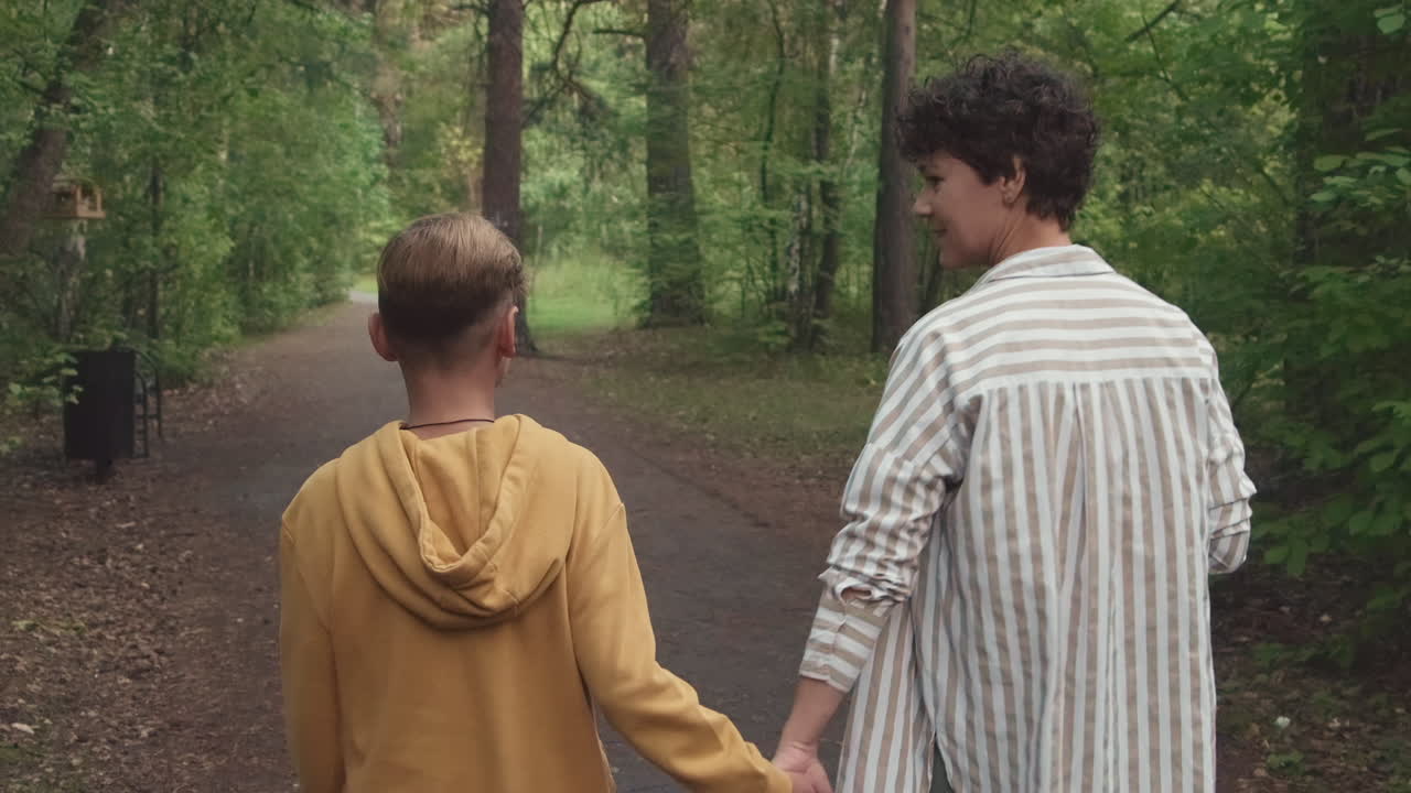 Mother And Son Walking In Forest