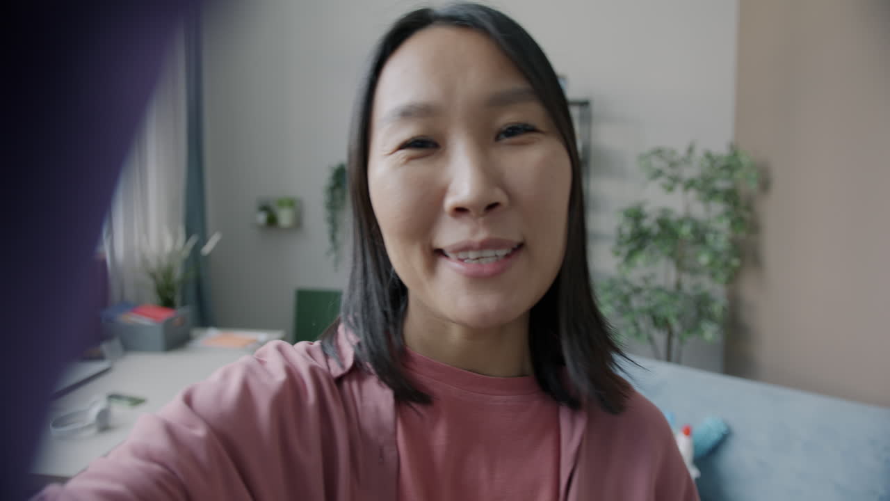 Smiling Asian Woman in a Pink Shirt
