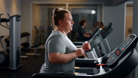 woman running on a treadmill in a gym
