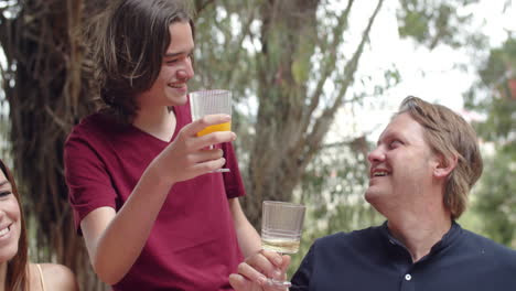 slow motion of happy caucasian family clinking glasses at picnic