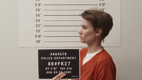 female inmate posing for camera during police mugshot procedure