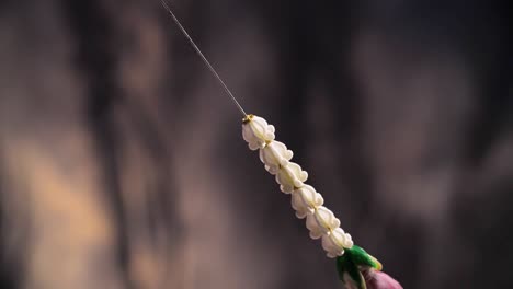 making of beautiful, exotic flower garland, close up