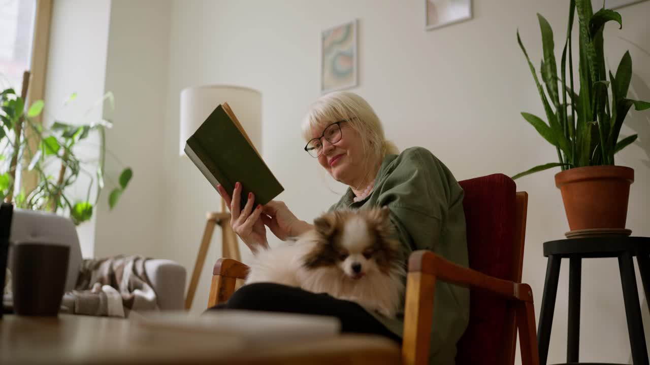Elderly Woman Reading with Her Dog at Home