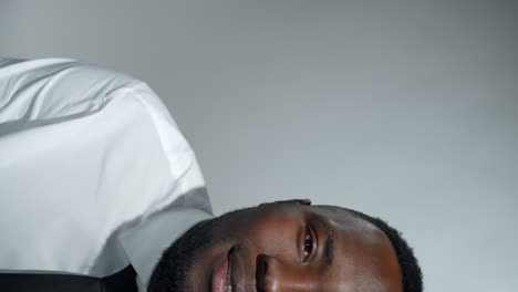 half face of smiling afro-american man in shirt and tie