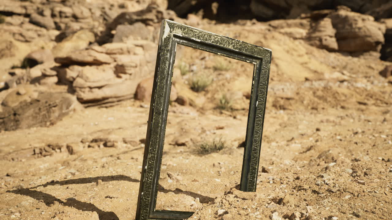 Empty frame standing alone in vast desert surrounded by rocky formations