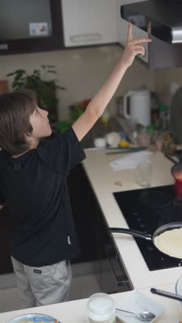 child cooking pancakes