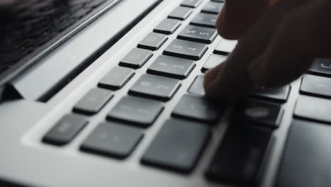 laptop keyboard being slid into position and fingers beginning to type