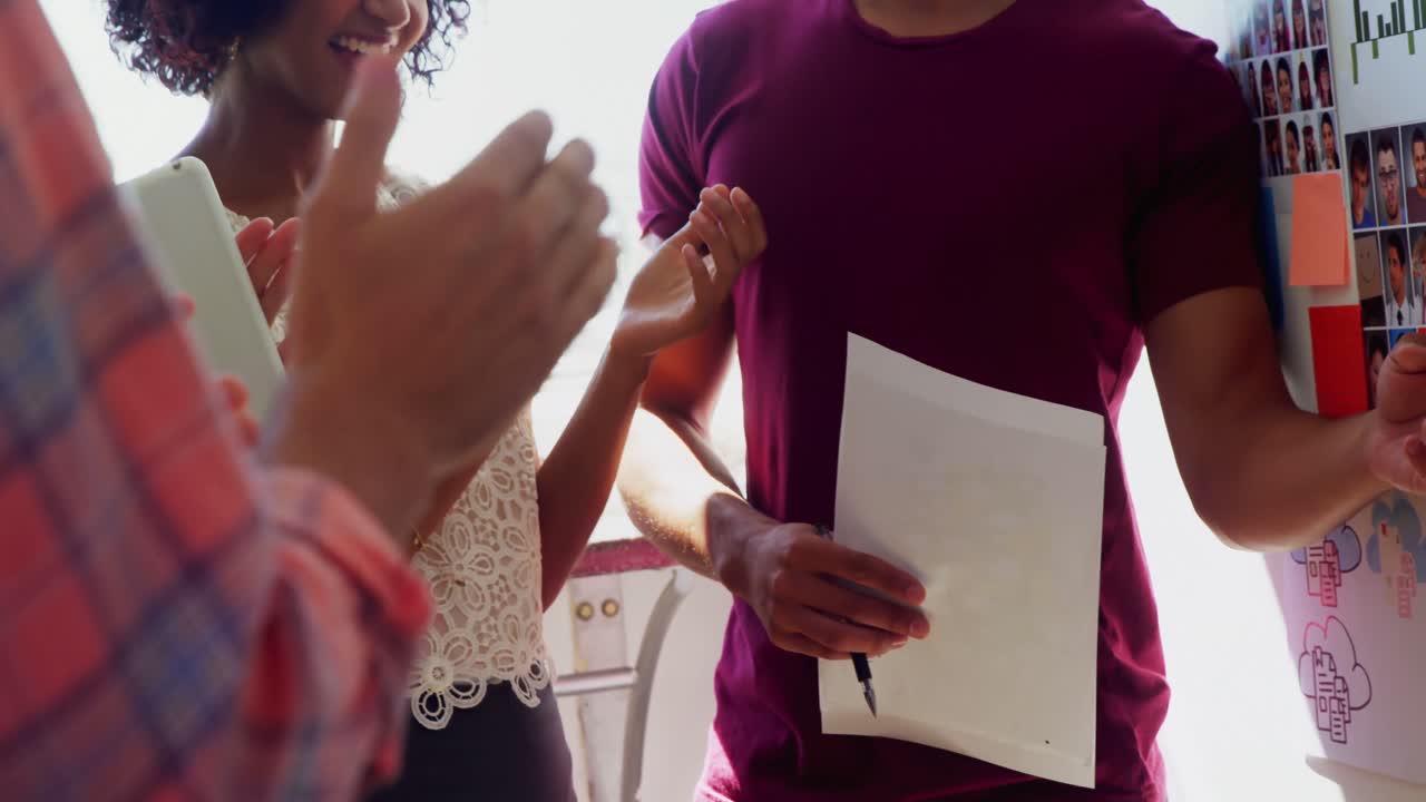 ejecutivo aplaudiendo a sus colegas mientras presenta 4k