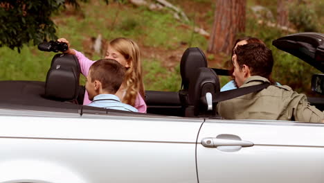 family in a silver car