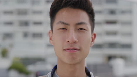 close up portrait happy young asian man tourist turns head smiling enjoying summer vacation independent teenage male looking cheerful