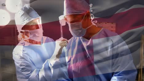 Animation-of-flag-of-england-waving-over-surgeons-in-face-masks