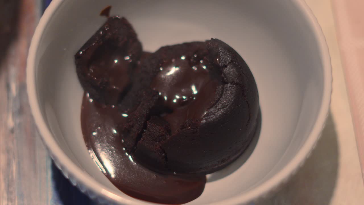 Top View of Indulgent Chocolate Pudding Dessert with Creamy Inside Running Over Inside of Bowl