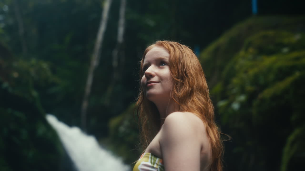 Woman near waterfall
