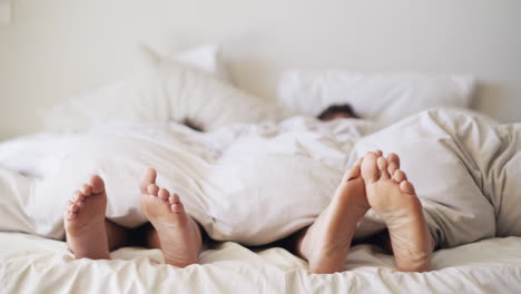 couple sleeping under blanket