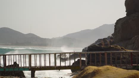 viewing platform by sea waves hit rocky shore, hang rai coast, vietnam