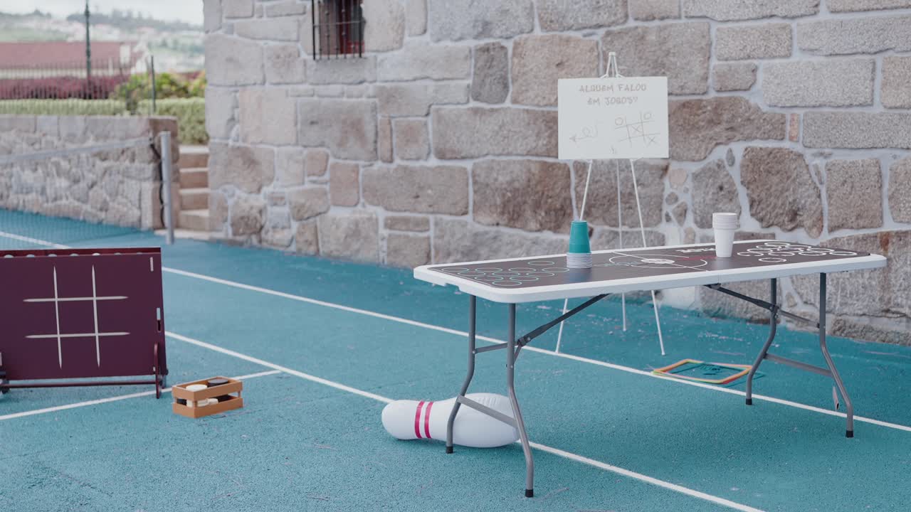 blue court with table games cups sign and tic tac toe board