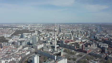 AERIAL:-Super-Close-Up-View-of-the-Alexanderplatz-TV-Tower-in-Berlin,-Germany-on-hot-summer-day