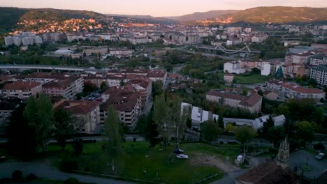 high aerial view of ourense, spain at sunset, showing the urban landscape and natural surroundings in soft evening light