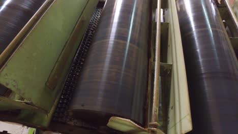 vintage machine conveyor rolls spinning at factory