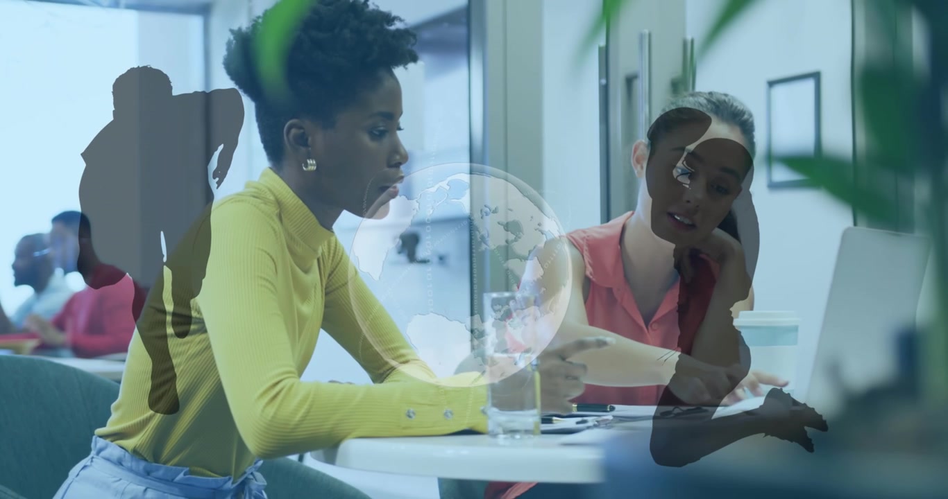 Animation of globe and rugby players silhouettes over diverse female colleagues discussing at office