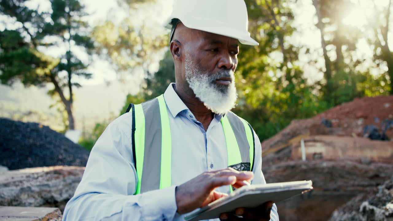 Construction worker using a digital tablet on site