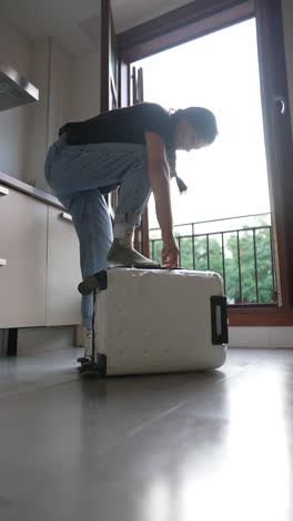 woman packing a suitcase in a kitchen