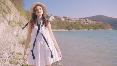 woman in a white dress by the lake