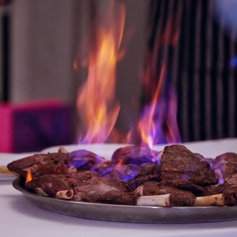 burning meat on table