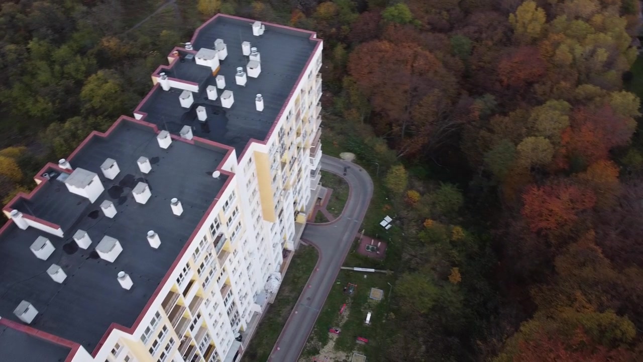 Aerial view of a drone flying over the residential buildings, roof shooting and architecture.