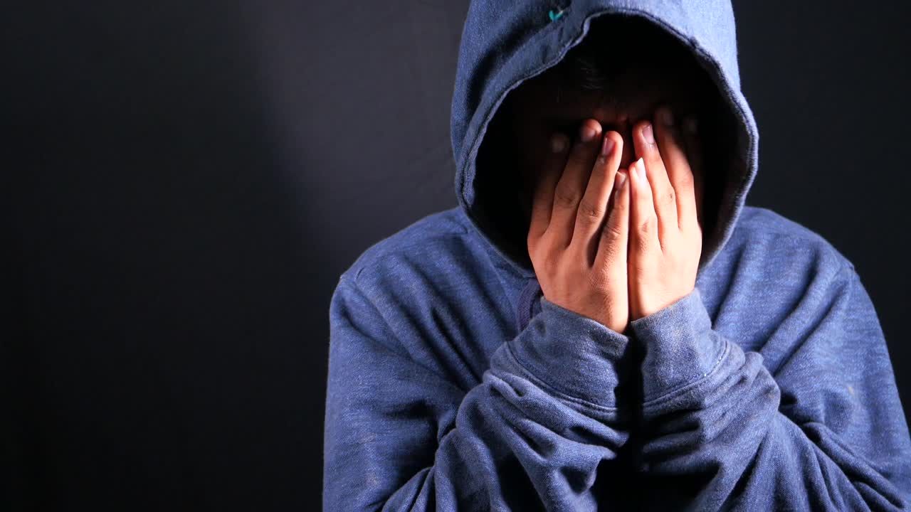 얼굴에 후드를 은 사람