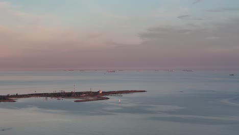ships waiting to enter the port near montevideo during a calm sunset
