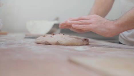 artisan bakers handling and shaping of raw dough