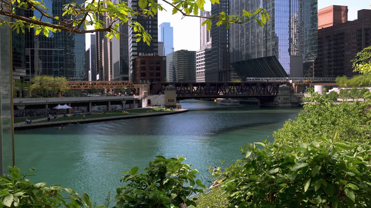 Train driving over the W Lake Street Bridge, sunny, summer day in Chicago, USA