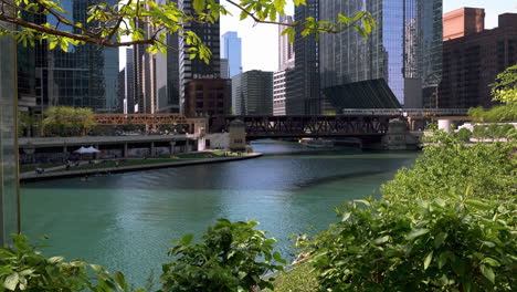 train driving over the w lake street bridge, sunny, summer day in chicago, usa