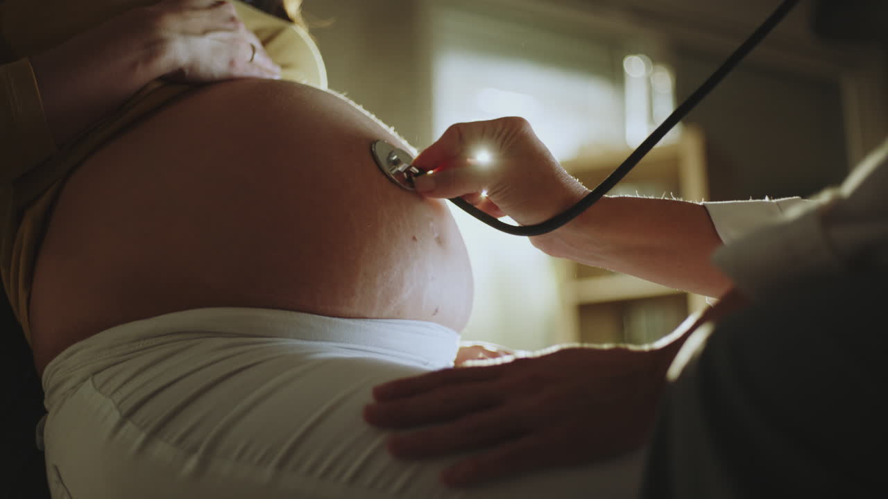 Doctor checking pregnant woman's fetus