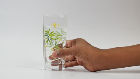 hand pick a glass of water on white background