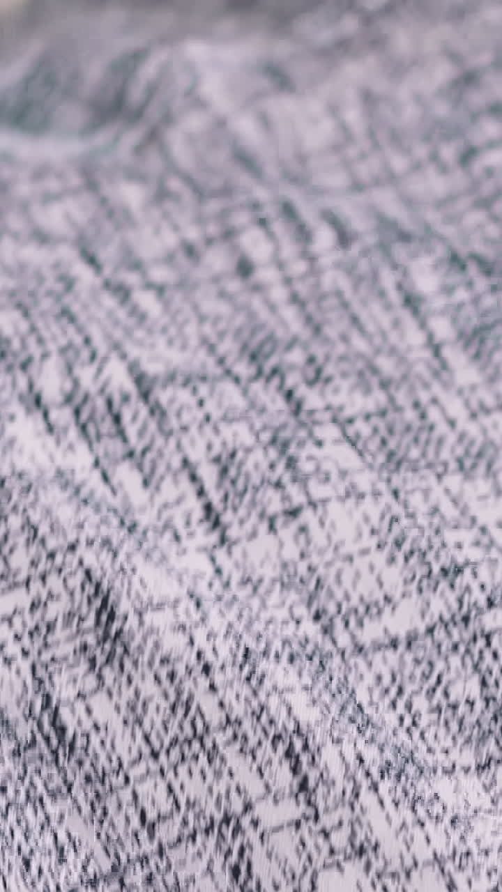 Man in patterned shirt puts on dark jacket extreme close view slow motion. Businessman wearing office suit in workplace. Formal clothes dresscode