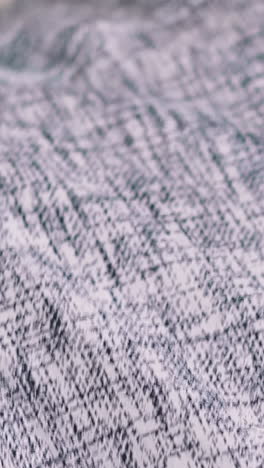 man in patterned shirt puts on dark jacket extreme close view slow motion. businessman wearing office suit in workplace. formal clothes dresscode