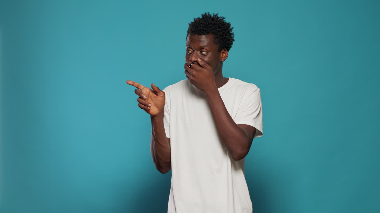 Portrait of person covering mouth with hands after telling secret