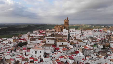 cinematic rotating view over village on top of hill with church