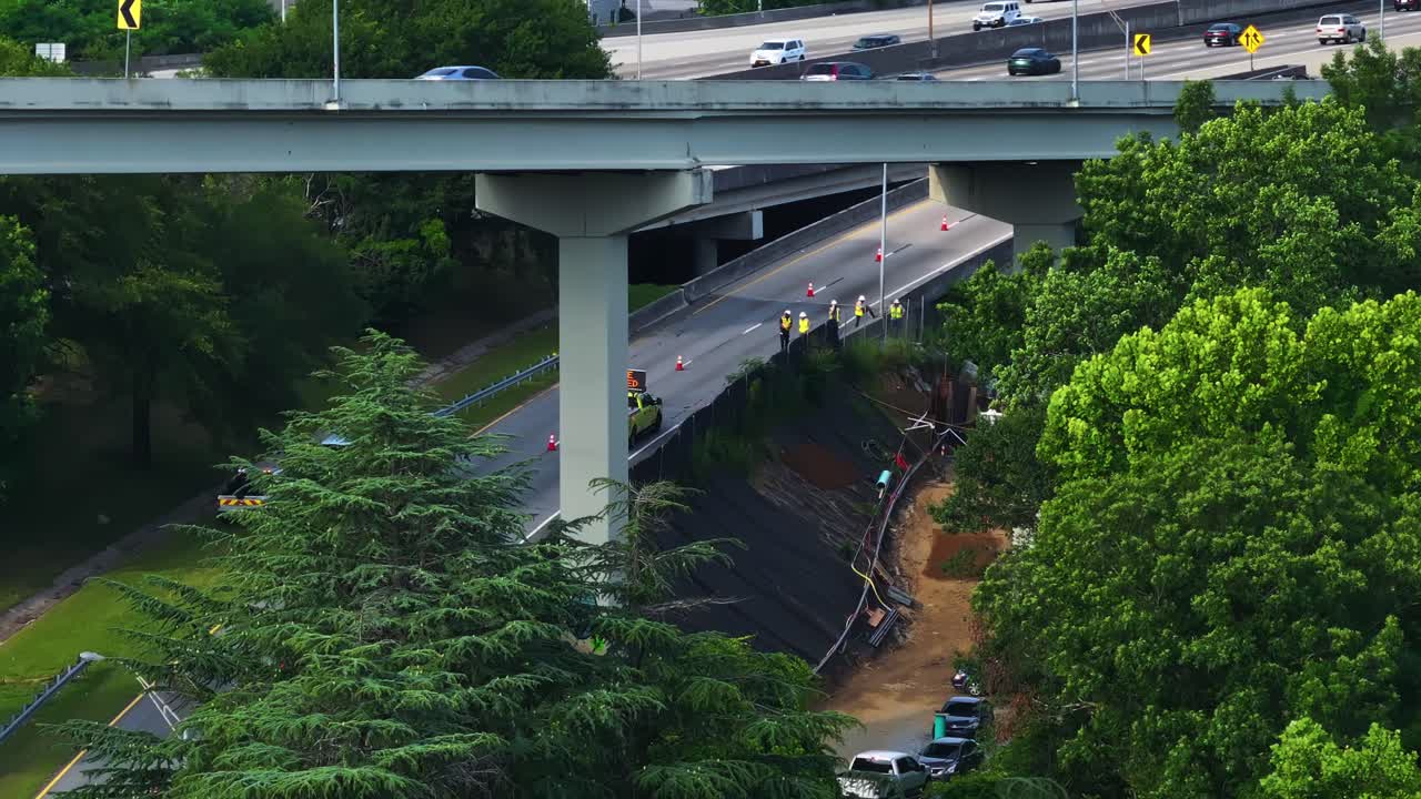 Workers Checking The Damage Of Erosion Near A Highway In Atlanta, Georgia, USA. - zoom out shot