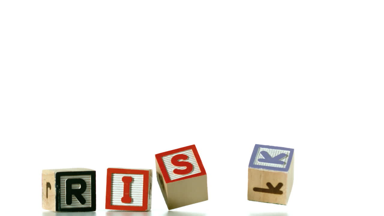 Blocks spelling out Risk in letters falling in row