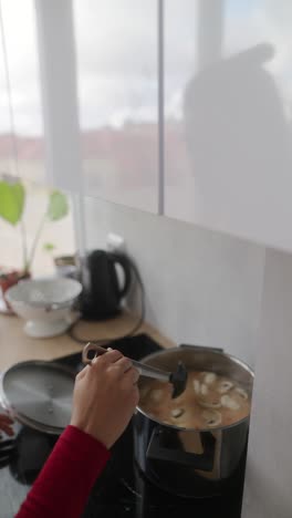 person cooking mushroom soup