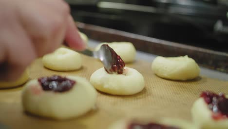 filling cookies with raspberry jam