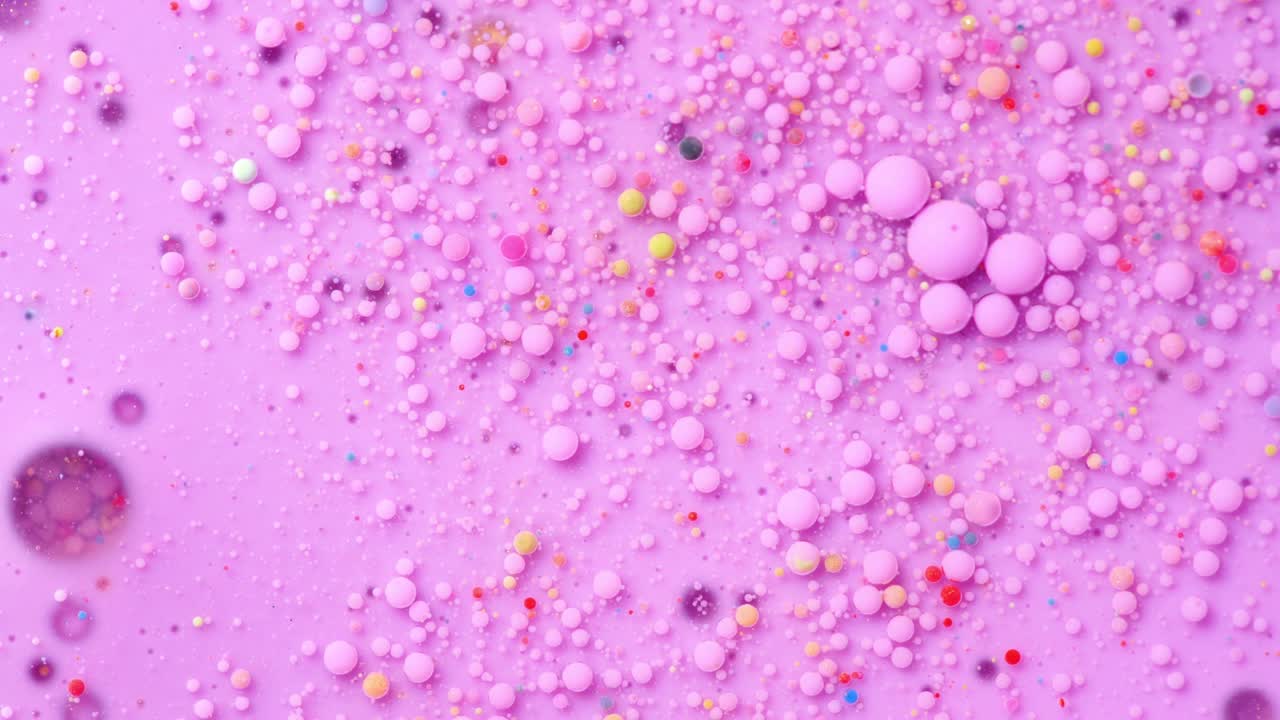 Colorful paint and bubbles abstract background 4k video