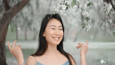 woman enjoying spring flowers in a park