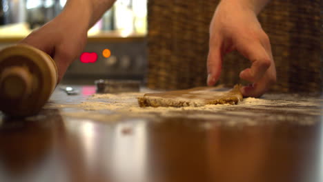 young male preparing gingerbread cookies for christmas