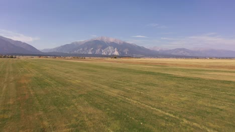 farm land and flying up to colorado mountain 4k drone