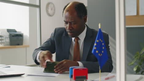 consular officer working with visa documents