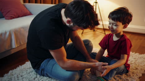 father and son bonding over putting on socks